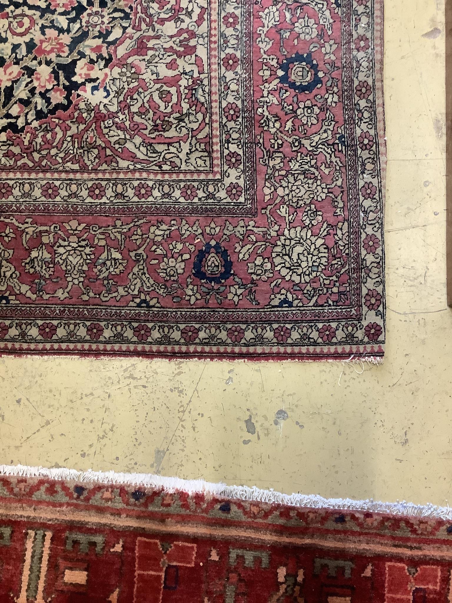 An Isphahan black ground rug with central foliate medallion, mulit-bordered, 202 x140cm